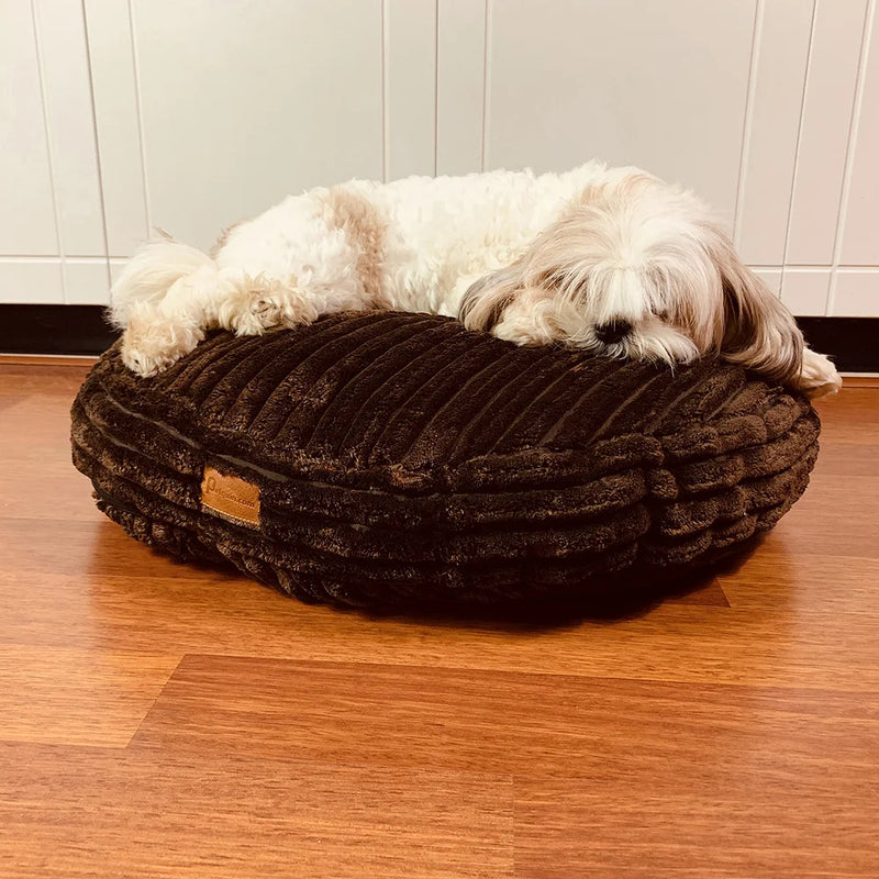 The Macaron Calming Dog Bed is made of cotton fabric and filled with polyester fiberfill.