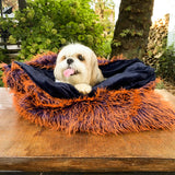 The Dorian Faux Fur Dog Bed is a large, washable bed for dogs that features a faux fur cover.
